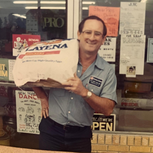 Old Time Farm Supply, Inc. staff inside the store carrying feed