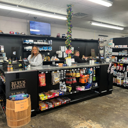 Old Time Farm Supply, Inc. staff inside the store behind the counter