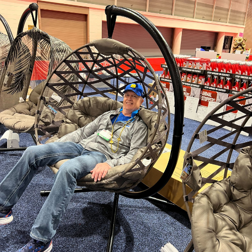 Old Time Farm Supply, Inc. staff inside the store sitting in an egg chair